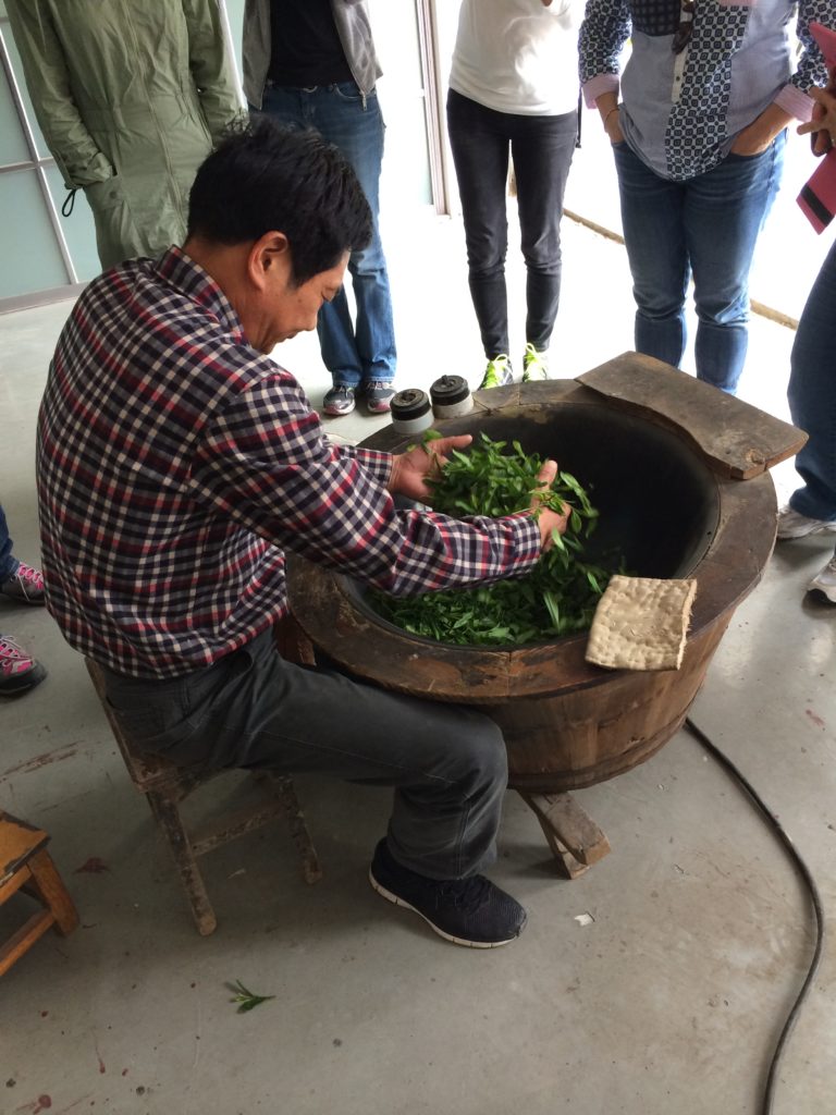 Long Jing green tea: Rolling and heating the leaves.